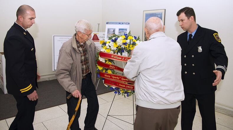 Retired Fire Chief Neil Mangan and retired Fire Capt. Forest Green place a wreath Nov. 21 in remembrance of Wright-Patterson Air Force Base firefighters who died in the line of duty. Mangan and Green both were among those who battled a blaze Nov. 21, 1961, which killed two of their fellow firefighters. Chase McGrath, 788th Civil Engineering Squadron district fire chief, and Steven McKee, International Association of Firefighters Local F88 secretary/treasurer, assisted in the wreath laying. (U.S. Air Force photo/R.J. Oriez)