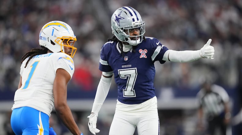 Dallas Cowboys cornerback Trevon Diggs (7) defends on Los Angeles Chargers wide receiver Quentin Johnston (1) during the first half of an NFL football game Sunday, Dec. 21, 2025, in Arlington, Texas. (AP Photo/Julio Cortez)
