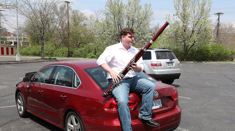 Eric Barga practices his bassoon while sitting on the trunk of his car in the Covenant Presbyterian Church parking lot Wednesday, May 2, 2018 just like he was recently when the Springfield Police Division received a 911 call reporting that he had a gun. Bill Lackey/Staff
