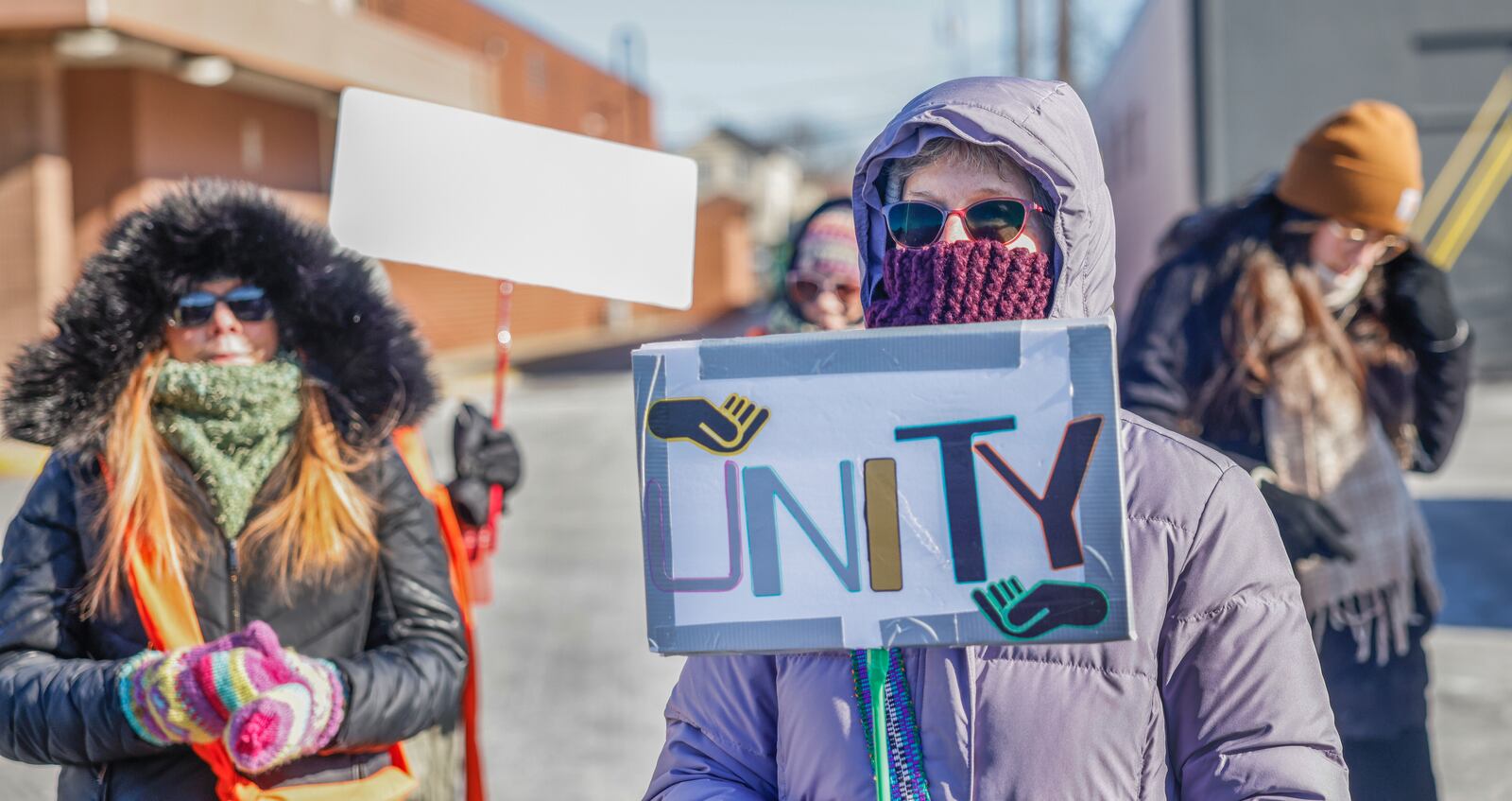 Maureen Dawn holds a "UNITY" sign during a Peace Walk for the National Day of Action hosted by Indivisible Springfield on Tuesday, Jan. 20, 2026, in Springfield. JOSEPH COOKE/STAFF