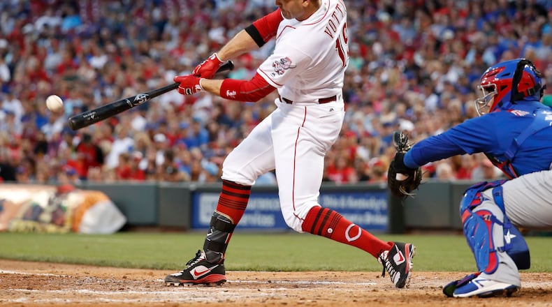 Cincinnati Reds’ Joey Votto hits an RBI single off Chicago Cubs starting pitcher Jake Arrieta during the fourth inning of a baseball game, Thursday, Aug. 24, 2017, in Cincinnati. (AP Photo/John Minchillo)