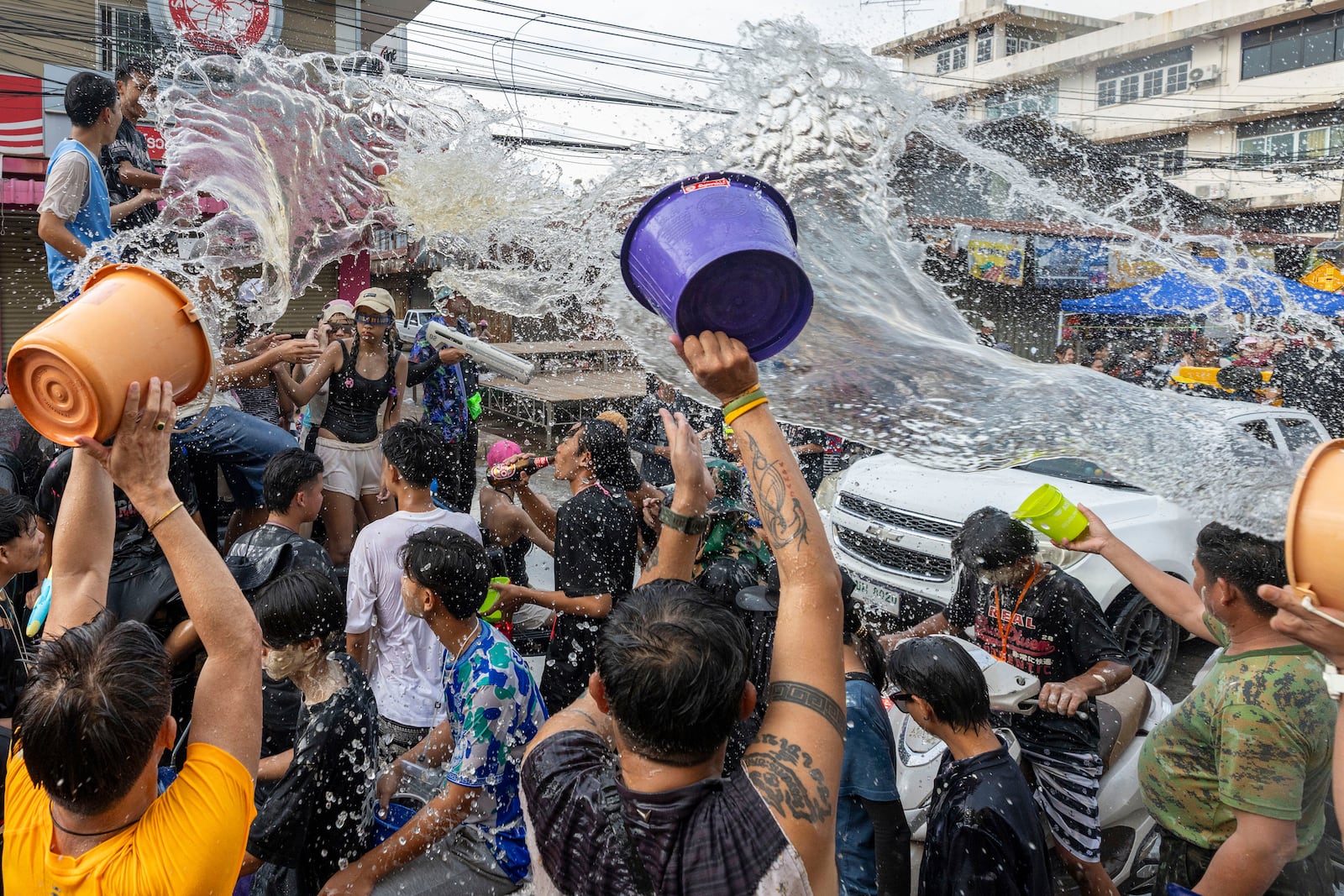 People splash water during the Songkran water festival to celebrate the Thai New Year in Prachinburi Province, Thailand, Sunday, April 13, 2025. (AP Photo/Wason Wanichakorn)