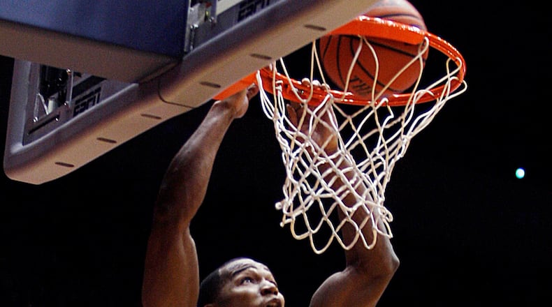 The University of Dayton’s Chris Wright slams one home against New Mexico at UD Arena on Jan. 1, 2011. Wright had 17 points and 14 rebounds in the game. Dayton Daily News file