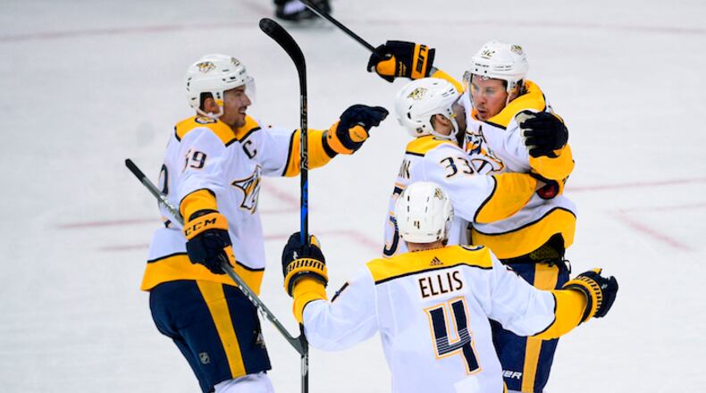 Nashville Predators center Ryan Johansen (92) celebrates his goal with left wing Viktor Arvidsson (33), of Sweden, defenseman Ryan Ellis (4) and defenseman Roman Josi (59), of Switzerland, during the third period of an NHL hockey game against the Washington Capitals, Thursday, April 5, 2018, in Washington. The Predators won 4-3. (AP Photo/Nick Wass)