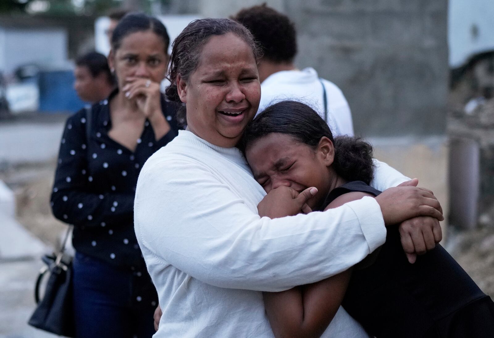 Family and friends grieve during the burial service of Marilenny Pilarte who died at the Jet Set nightclub when its roof collapsed, in Haina, Dominican Republic, Thursday, April 10, 2025. (AP Photo/Matias Delacroix)