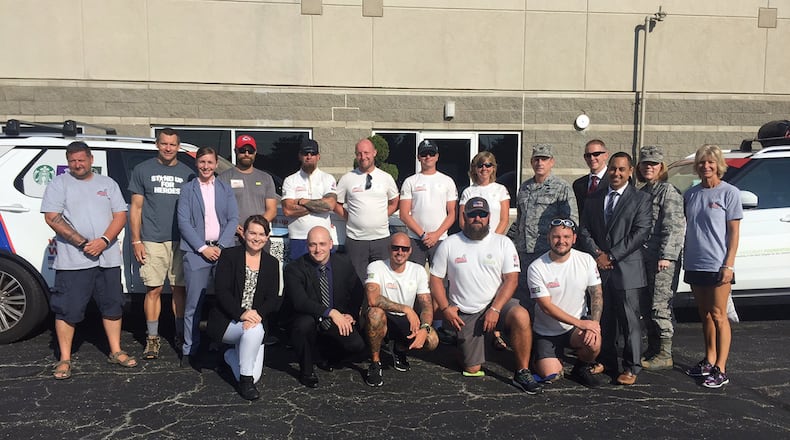 Air Force Base, welcome the Walk of America and Walking With The Wounded group Aug. 28 outside the Hope Hotel. To the left of Col. Garry Little, 1st Field Investigations Region commander, Air Force Materiel Command, is Adele Loar, a U.S. Air Force retired master sergeant and OSI special agent and former Security Forces member who was wounded in Iraq. Second from right is Lt. Col. Andrea O’Connor, 10th Field Investigations Squadron commander. (Skywrighter photo/Amy Rollins)