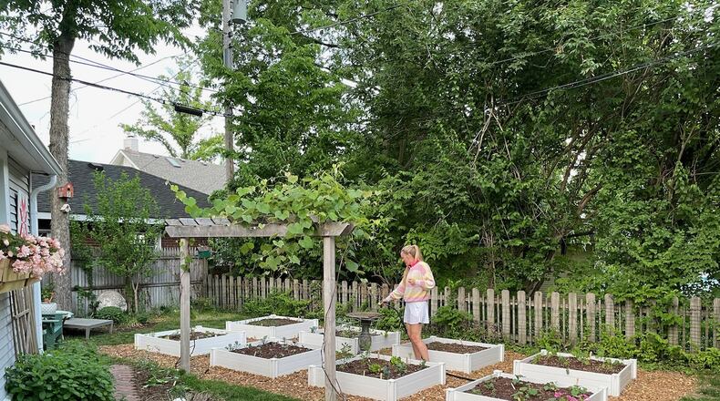 Megan Smith fills the bird bath in her garden. Every morning she “puts her feet in the grass and says hello to the earth.” CONTRIBUTED PHOTOS