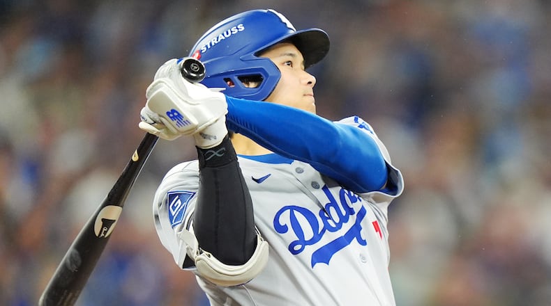 Los Angeles Dodgers' Shohei Ohtani hits a two-run home run against the Toronto Blue Jays during the seventh inning of Game 1 of baseball's World Series in Toronto, Friday, Oct. 24, 2025. (Frank Gunn/The Canadian Press via AP)