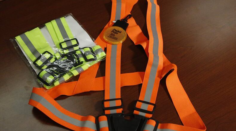 A blinking safety light and reflective belts are shown at the Miami Valley Regional Planning Commission. The MVRPC, ODOT and the City of Dayton are conducting a traffic safety study for North Main Street after several pedestrians have been hit between Great Miami Boulevard and Shiloh Springs Road. TY GREENLEES / STAFF