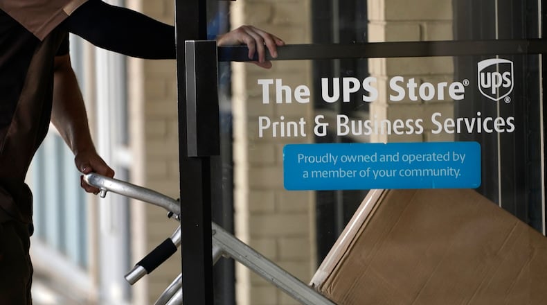 FILE - A UPS driver enters a United Parcel Service store with packages in Jackson, Miss., July 26, 2021. (AP Photo/Rogelio V. Solis, File)