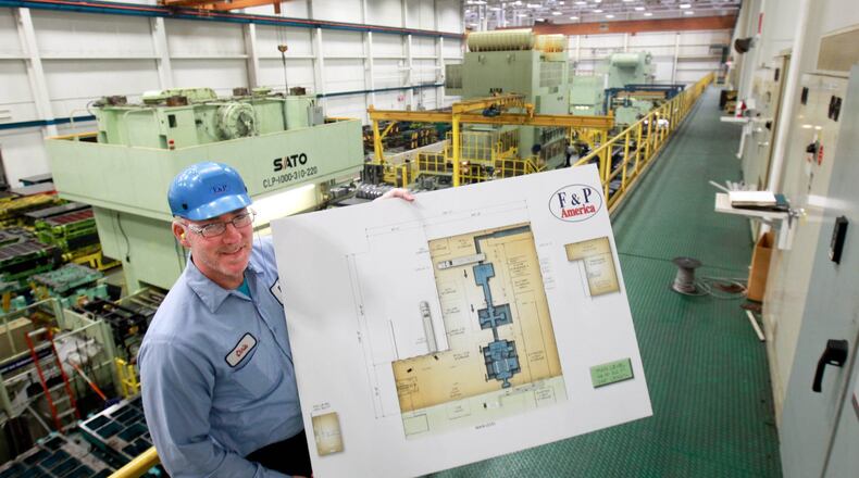In this 2014 file photo, F&P America Manufacturing Platform manager Chris Peltier shows an architectural rendering of the $2.5 million expansion that was to begin soon.