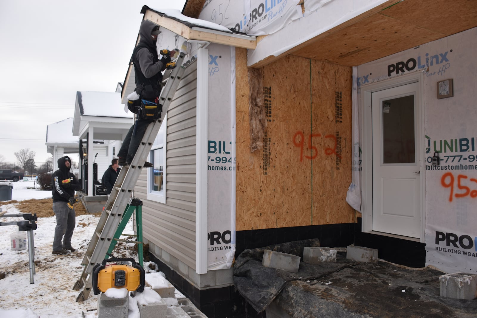 Contractors work on a home 727 McCleary Ave. in Dayton's Fairview neighborhood. Omega CDC, County Corp and other community partners are going to help build 30 new homes in northwest Dayton over the next three years. CORNELIUS FROLIK / STAFF