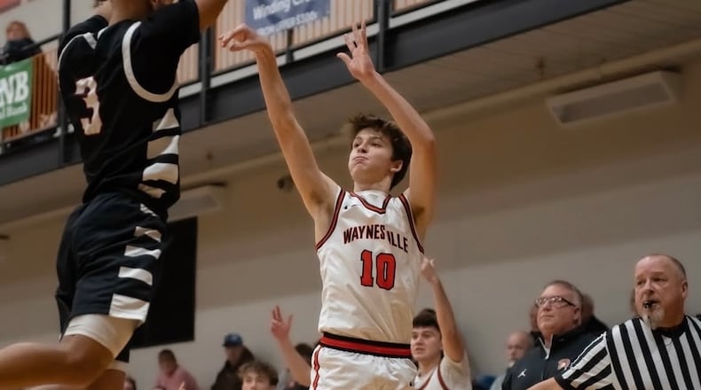 Waynesville coach Brandon Philpot (right) watches as junior Ross Barrett fires up a shot during a recent game. CARSON HALE / CONTRIBUTED