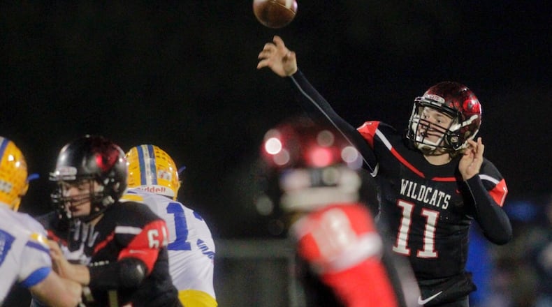 Franklin quarterback Braden White throws a pass over teammate Nathaneel Rudd (64) during Saturday night’s Division III, Region 12 semifinal against St. Marys Memorial at Wayne’s Heidkamp Stadium. NICK GRAHAM/STAFF