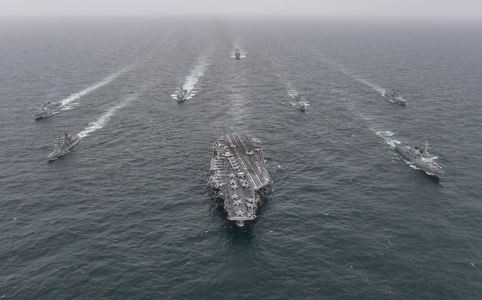 FILE - In this photo provided by the South Korea Defense Ministry, South Korean Navy's destroyer Yulgok Yi I, front row right, U.S. Navy's aircraft carrier USS Nimitz, center, Japan Maritime Self-Defense Force's Umigiri, front row left, sail in formation during a joint naval exercise in international waters off South Korea's southern island of Jeju on April 4, 2023. (South Korea Defense Ministry via AP, File)