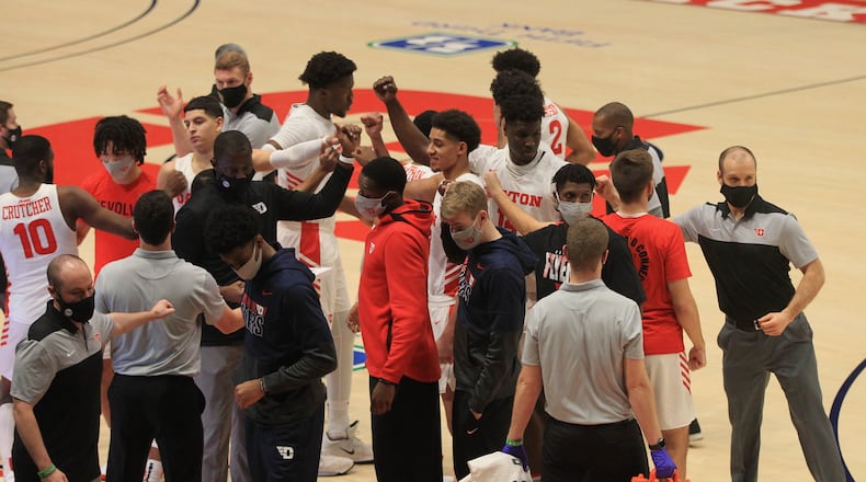 Dayton's Mustapha Amzil, Moulaye Sissoko, Jordy Tshimanga and Brett Comer huddle before a game against La Salle on Wednesday, Dec. 30, 2020, at UD Arena. David Jablonski/Staff