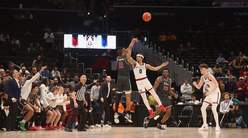 Xzayvier Brown, of Saint Joseph’s, makes a 3-pointer in overtime against Dayton on Friday, March 14, 2025, in the quarterfinals of the Atlantic 10 Conference tournament at Capital One Arena in Washington, D.C. David Jablonski/Staff