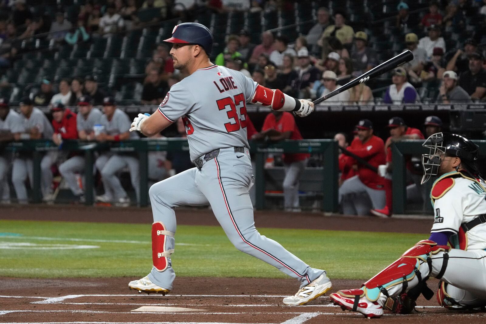Washington Nationals' Nathaniel Lowe hits an RBI double against the Arizona Diamondbacks in the first inning during a baseball game, Saturday, May 31, 2025, in Phoenix. (AP Photo/Rick Scuteri)