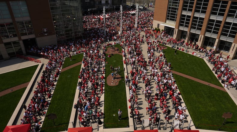 Fans lines up outside to enter the stadium before of the opening-day baseball game between the Cincinnati Reds and the Boston Red Sox in Cincinnati, Thursday, March 26, 2026. (AP Photo/Carolyn Kaster)