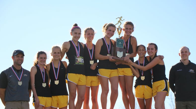 Centerville celebrates the Division I state cross country championship in 2016. Longtime Elks coach David Dobson (left) was recently named the head coach at the Unviersity of Dayton. CONTRIBUTED PHOTO
