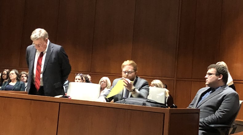 John Austin Hopkins, at left, with lawyers David Anthony Chicarelli and David Allen Chicarelli, at right. STAFF/LAWRENCE BUDD