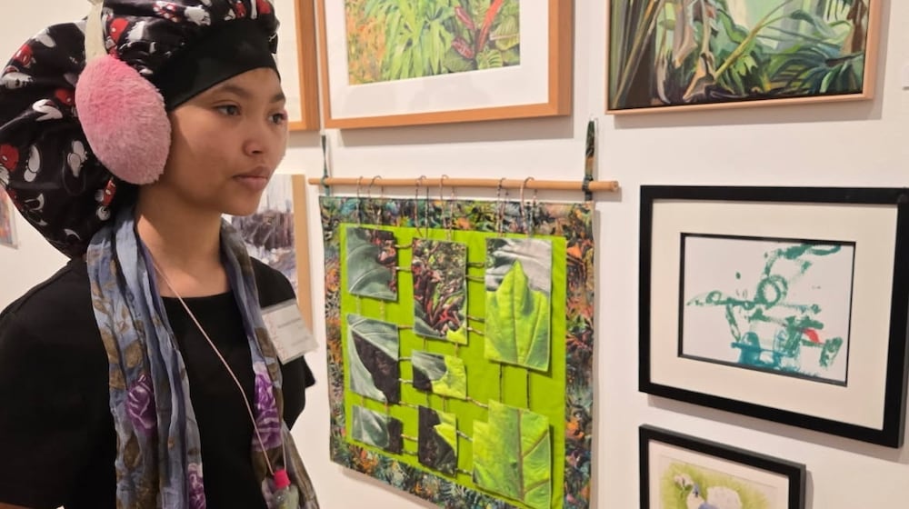 Kaydence Denson looks over her artwork as one of 10 artists who will be celebrated with a special event on Thursday, Nov. 6 at the Springfield Museum of Art. CONTRIBUTED