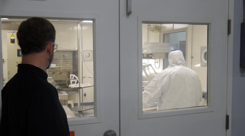 An employee at Silfex in Eaton looks in on some of the manufacturing going on. File photo