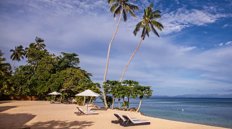 Sun pushes away wispy clouds above Beach Bungalow No. 1, at Tides Reach Resort, on Taveuni, Fiji's Garden Isle. (Steve Haggerty/Colorworld/TNS)
