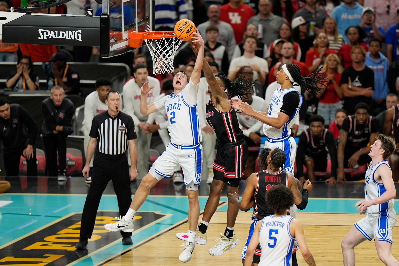 Duke's Cooper Flagg (2) shoots as Houston's Joseph Tugler (11) defends during the second half in the national semifinals at the Final Four of the NCAA college basketball tournament, Saturday, April 5, 2025, in San Antonio. (AP Photo/Stephanie Scarbrough)