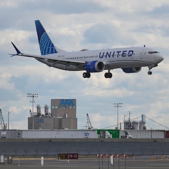 A plane lands at Newark International Airport in Newark, N.J., Thursday, Nov. 6, 2025. (AP Photo/Seth Wenig)