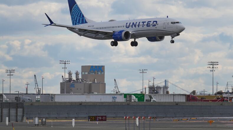 A plane lands at Newark International Airport in Newark, N.J., Thursday, Nov. 6, 2025. (AP Photo/Seth Wenig)