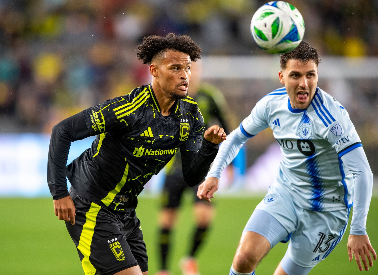 Columbus Crew forward Jacen Russell-Rowe (19) and CF Montréal defender Luca Petrasso (13) fight for a loose ball during the first half of an MLS soccer match on Saturday, April 5, 2025, in Columbus, Ohio. (AP Photo/Tanner Pearson)
