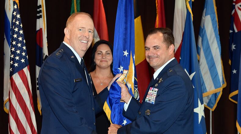 Lt. Gen. Robert McMurray (left), Air Force Lifecycle Management Center commander, passes the guidon to Brig. Gen. Sean Farrell as Farrell assumes command of the Air Force Security Assistance and Cooperation Directorate during a change of command ceremony at Wright-Patterson Air Force Base July 18. Farrell’s previous assignment prior to commanding AFSAC was as director, Strategic Plans, Programs and Requirements, Air Force Special Operations Command, Hurlburt Field, Florida. (U.S. Air Force photo/Al Bright)