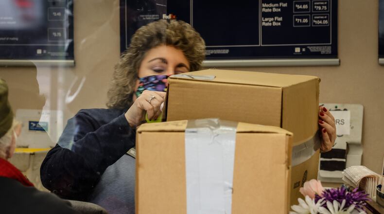 Dayton USPS Sales and Service Associate Kim Bowser ships packages Tuesday Nov. 9, 2021. The major carriers have all released their holiday shipping deadlines for 2021. JIM NOELKER/STAFF