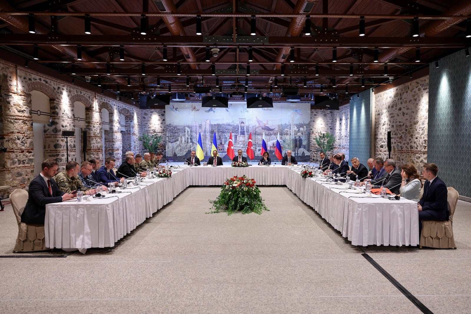 In this handout photo released by Turkish Foreign Ministry, Turkish Foreign Minister Hakan Fidan, center, chairs a meeting between delegations from Russia, right, and Ukraine, left, at Dolmabahce palace in Istanbul, Turkey, Friday, May 16, 2025. (Murat Gok/Turkish Foreign Ministry via AP)