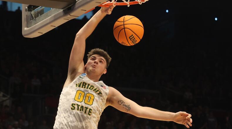 Wright State’s Grant Basile slam dunks the ball against Bryant Wednesday, March 16, 2022 during the First Four tournament at UD Arena. BILL LACKEY/ STAFF