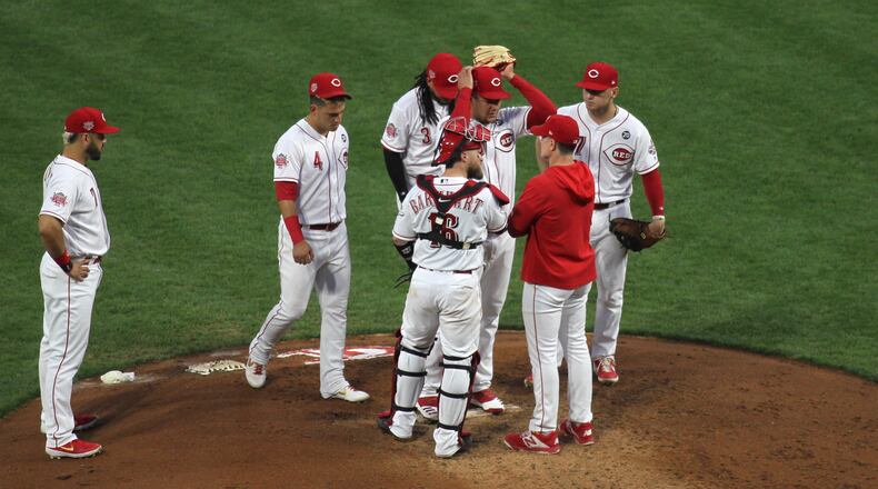 Reds manager David Bell visits the mound to take out starter Luis Castillo in the fifth inning during a game against the Cardinals on Friday, Aug. 16, 2019, at Great American Ball Park in Cincinnati. David Jablonski/Staff