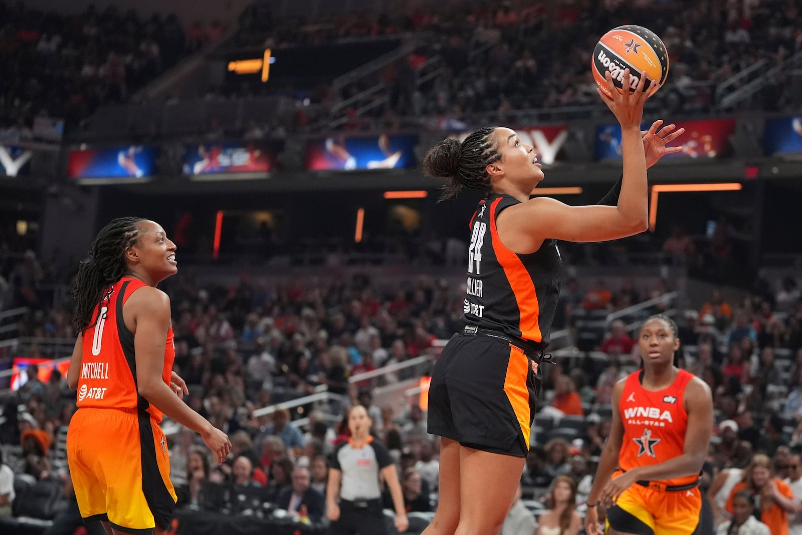 Minnesota Lynx's Napheesa Collier, right, shoots against Indiana Fever's Kelsey Mitchell during the second half of a WNBA All-Star basketball game, Saturday, July 19, 2025, in Indianapolis. (AP Photo/Michael Conroy)