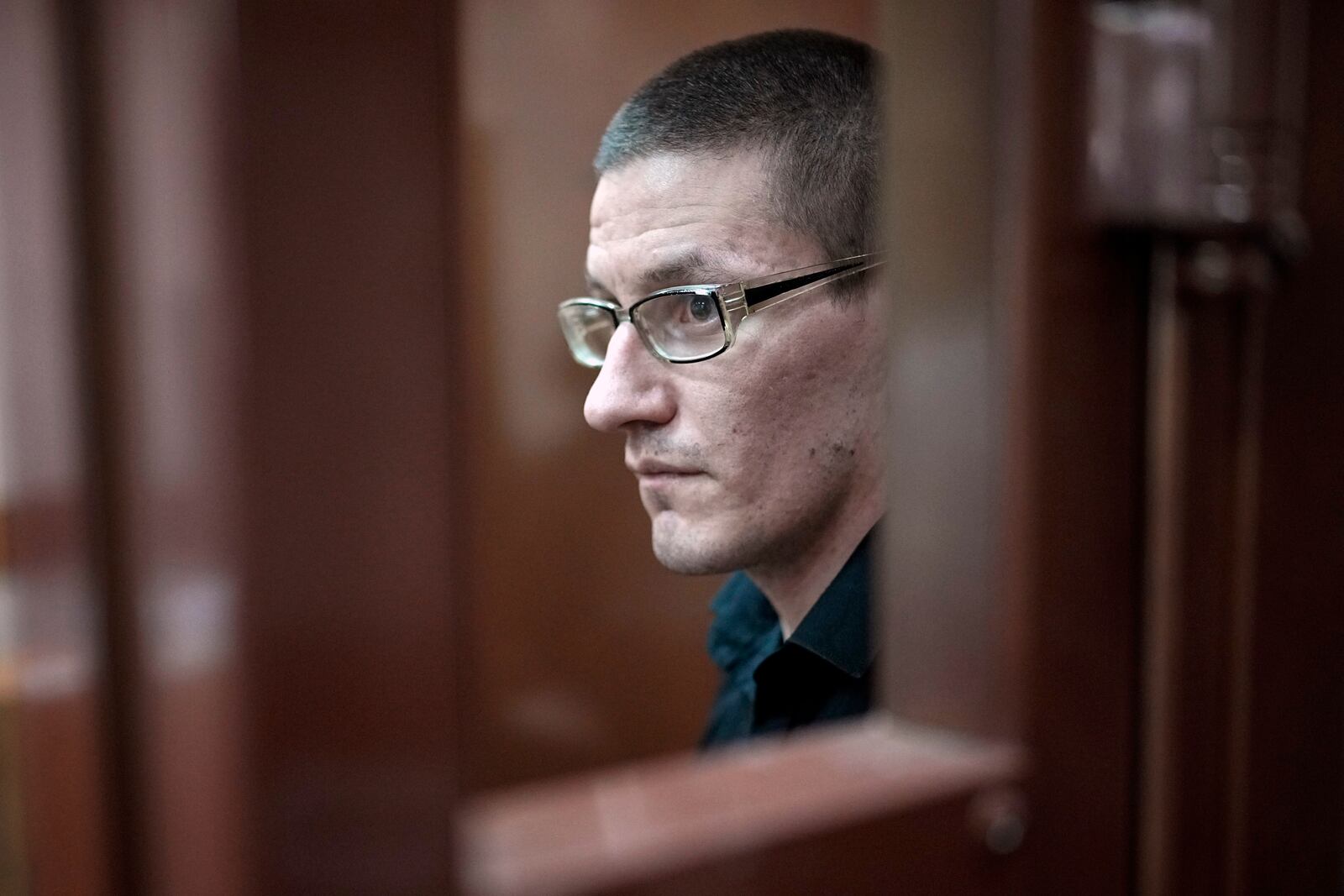 FILE - Robert Woodland, a Russia-born U.S. citizen, stands in a glass cage during a court hearing, July 4, 2024, in Moscow, Russia. (AP Photo/Alexander Zemlianichenko, File)