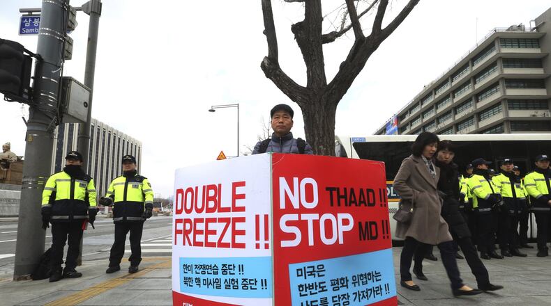 A protester stands to oppose the United States’ policies against North Korea near U.S. Embassy in Seoul, South Korea, Friday, March 9, 2018. After months of trading insults and threats of nuclear annihilation, Trump agreed to meet with North Korean leader Kim Jung Un by the end of May to negotiate an end to Pyongyang’s nuclear weapons program, South Korean and U.S. officials said Thursday. No sitting American president has ever met with a North Korea leader. The signs read: “Oppose Terminal High-Altitude Area Defense (THAAD) .” (AP Photo/Ahn Young-joon)
