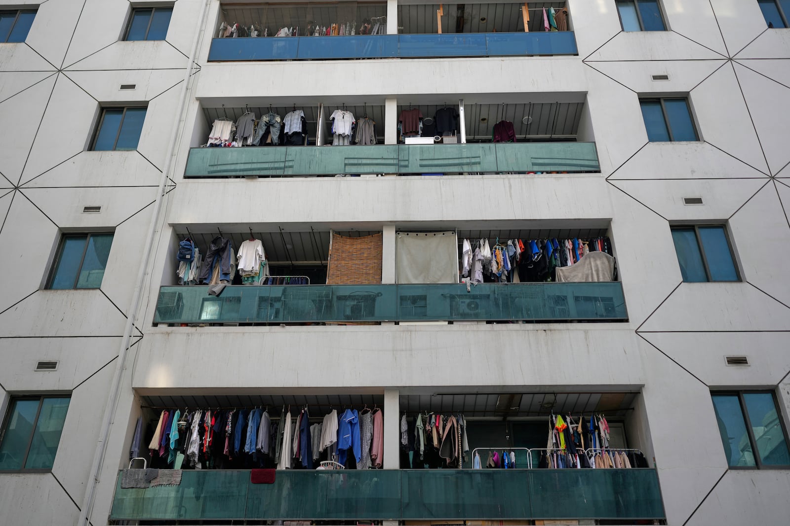 Clothes dry on balconies of a residential building in Dubai, United Arab Emirates, Friday, July 4, 2025. (AP Photo/Altaf Qadri)