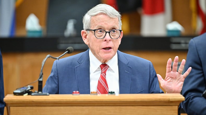 Gov. Mike DeWine (right) speaks during a news conference on Monday, Dec. 1 at Dayton City Commission Office. BRYANT BILLING/STAFF
