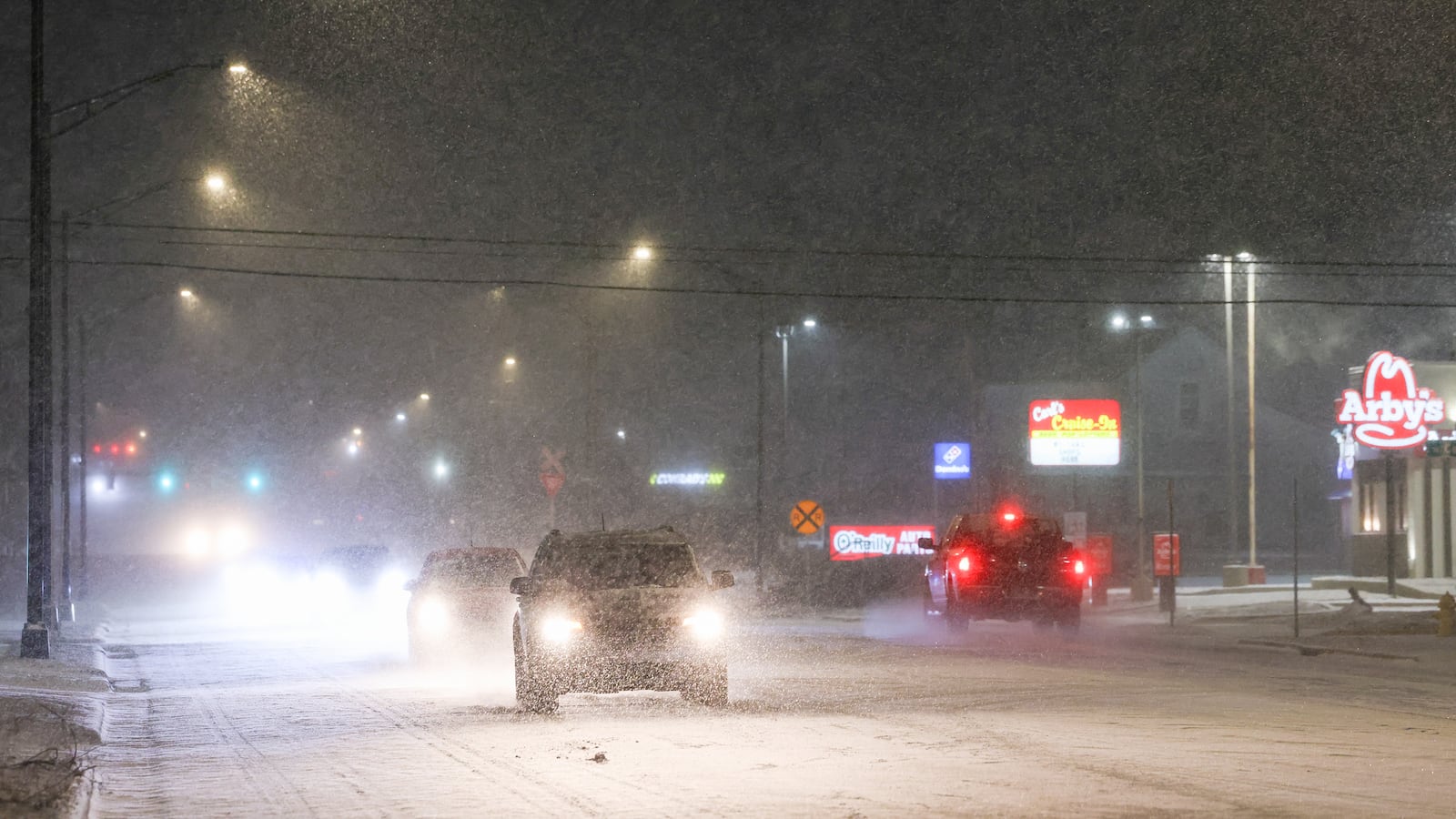 Vehicles drive on West Main Street in Troy on Saturday, Jan. 24. The National Weather Service is predicting the Miami Valley will receive between eight to 12 inches of snow as Winter Storm Fern moves through the area. BRYANT BILLING/STAFF