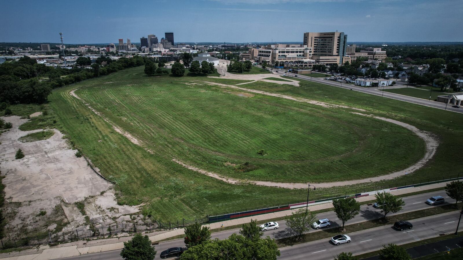 The former Montgomery County Fairgrounds property is in the foreground, with Miami Valley Hospital at top right-center, and downtown Dayton buildings visible in the distance top left-center. JIM NOELKER/STAFF