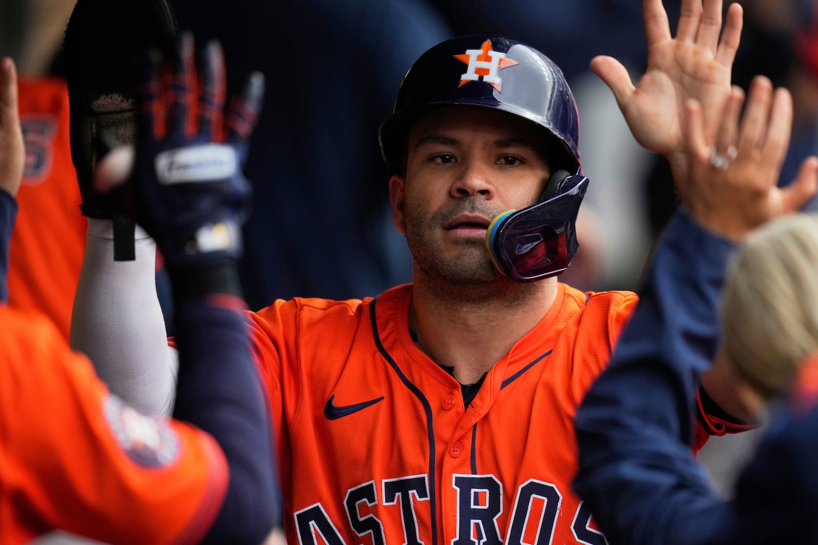 Houston Astros' Jose Altuve is congratulated in the dugout after scoring in the fifth inning of a baseball game against the Cleveland Guardians in Cleveland, Friday, June 6, 2025. (AP Photo/Sue Ogrocki)