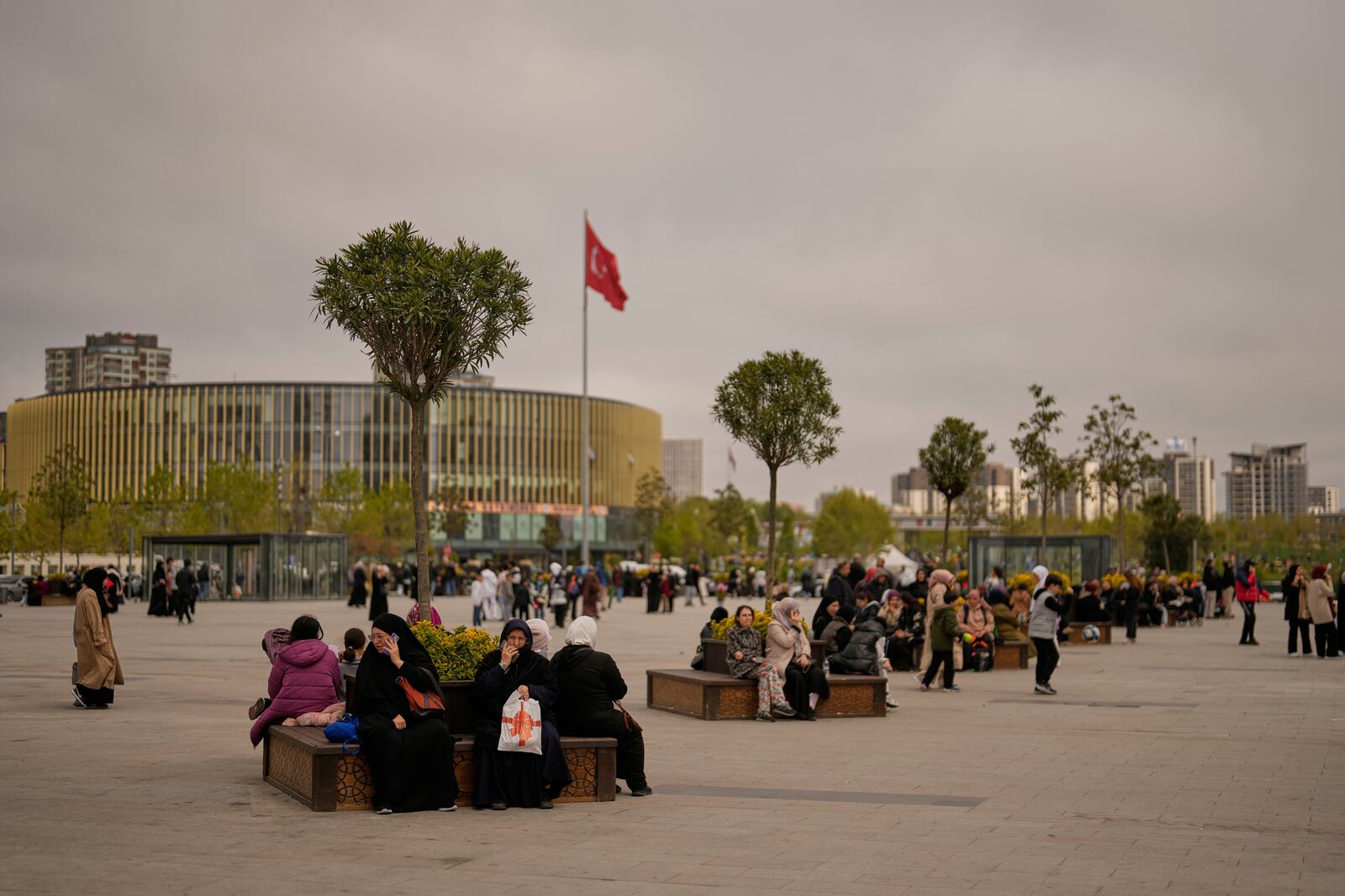 People gather outdoors following an earthquake shock with a preliminary magnitude of 6.2, in Istanbul, Turkey, Wednesday, April 23, 2025. (AP Photo/Khalil Hamra)
