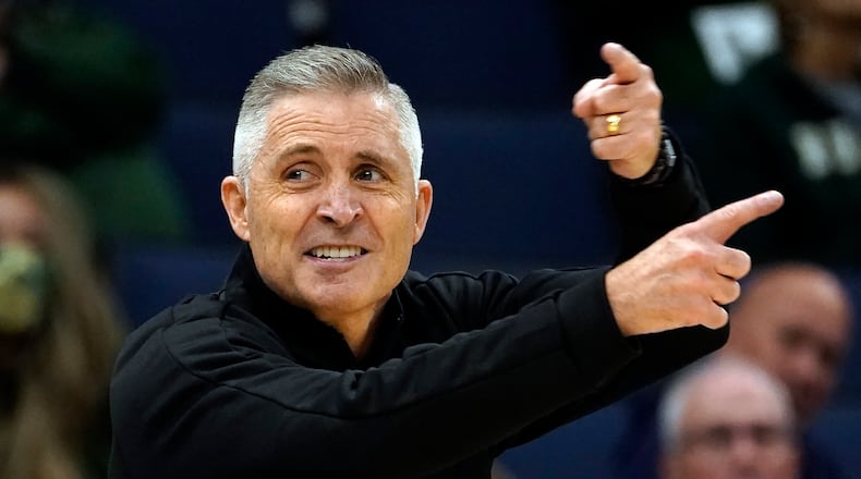 FILE -South Florida head coach Brian Gregory calls a play during the first half of an NCAA college basketball game against Auburn Friday, Nov. 19, 2021, in Tampa, Fla. South Florida basketball coach Brian Gregory was fired Friday, March 10, 2023, one day after the Bulls lost 73-58 to East Carolina in the opening round of the American Athletic Conference tournament. Gregory went 79-107 over six seasons at USF. The Bulls were 14-18 this season.(AP Photo/Chris O'Meara, File)