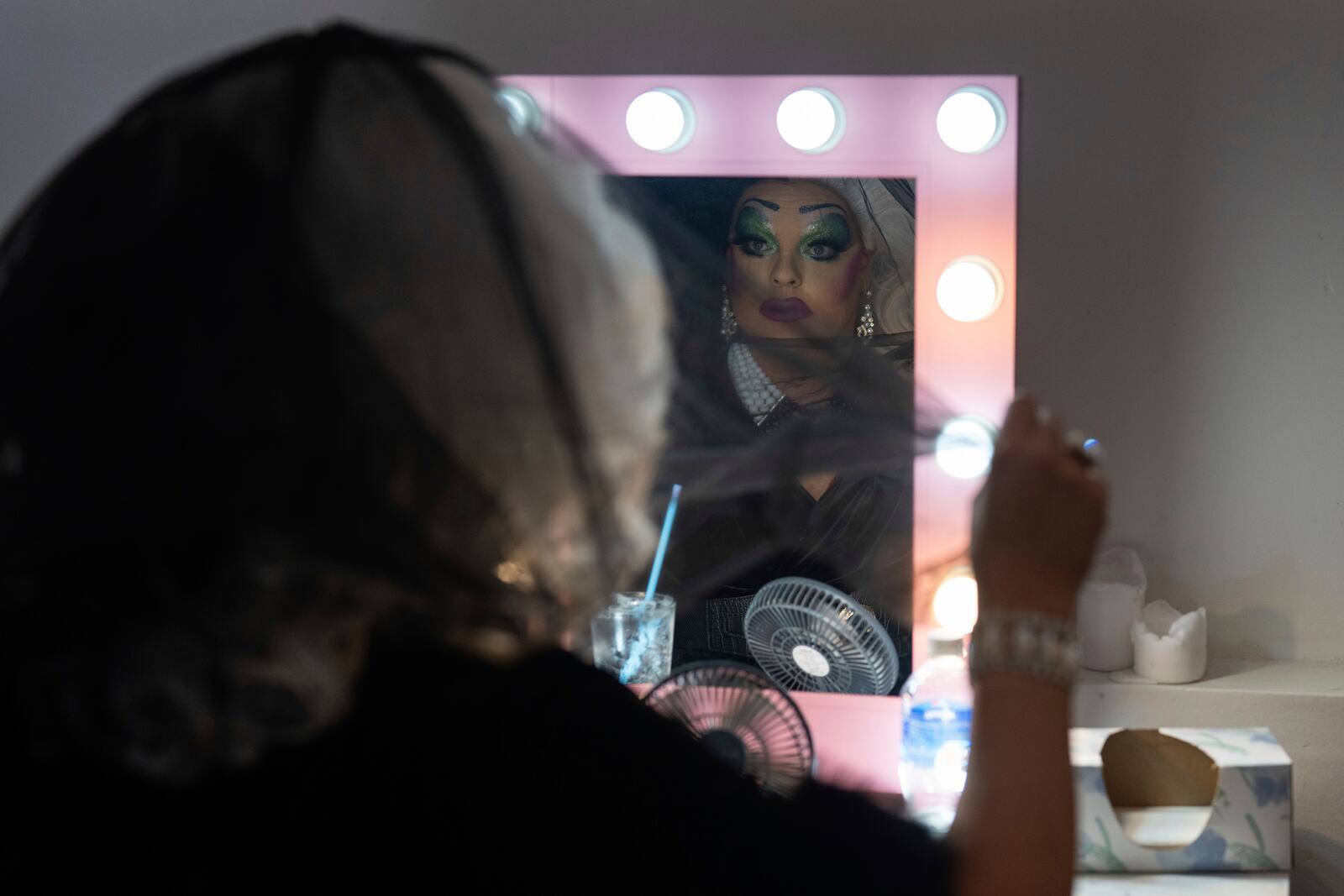 Drag queen Valerie DeVille adjusts her veil before performing in a "blaze and praise" drag brunch at Bar Carlo on Sunday, April 20, 2025, in Portland, Ore. (AP Photo/Jenny Kane)