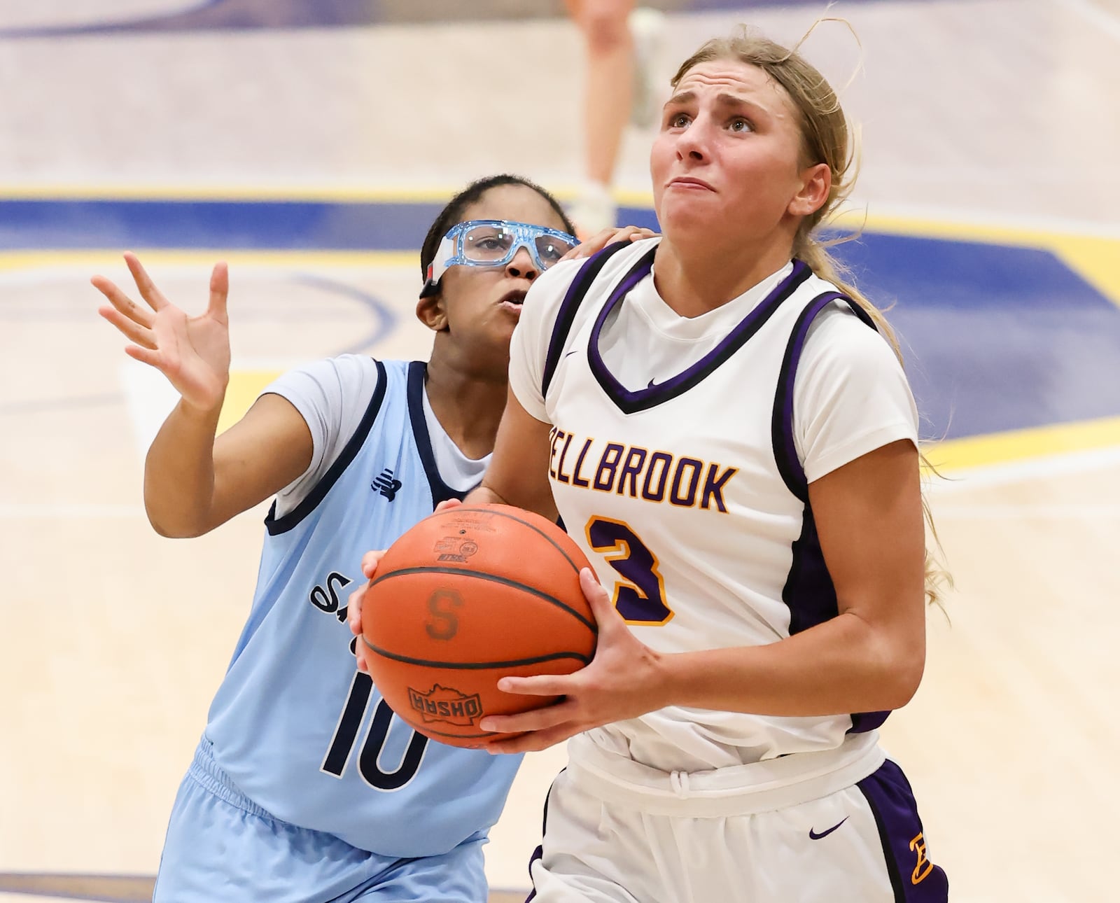 Bellbrook sophomore guard Libby Bunsold drives with pressure from Fairborn's Jordyn Brown during a Division III second-round game on Friday, Feb. 20 at Springfield High School. Bunsold scored 16 points in the squad's 73-20 victory. BRYANT BILLING / STAFF