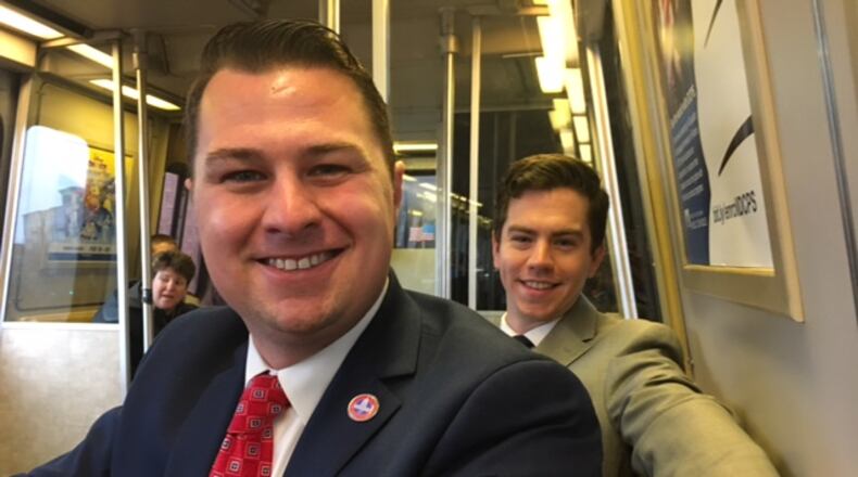 Nick Brusky, left, and Sam Buchan commute on the Metro on Friday. Brusky’s resignation as a Butler Twp. trustee took effect Friday. CONTRIBUTED